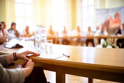 Blurred photo of people meeting at a round table